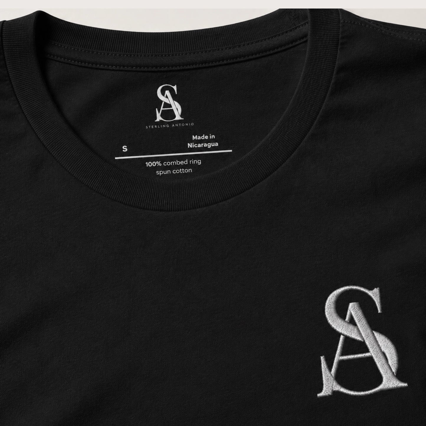 Black t-shirt with a logo and text on a white background