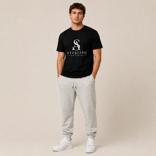 Male model wearing the black Sterling Antonio Legacy Tee with gray joggers and white sneakers.