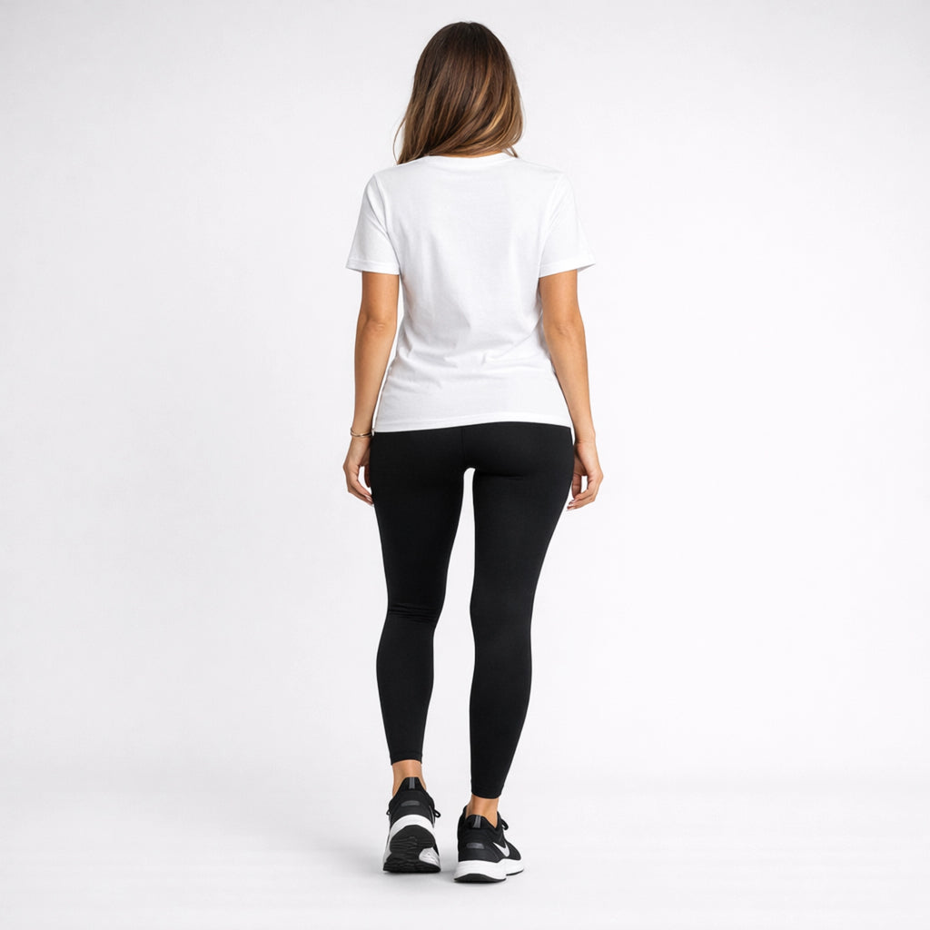 Person wearing a white t-shirt and black leggings on a white background
