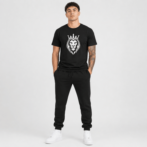 Male fashion model wearing a black t-shirt featuring a white crowned lion graphic with matching black sweatpants and white sneakers.