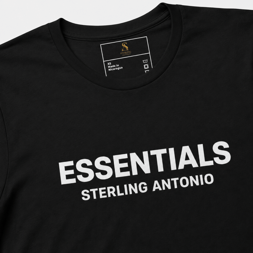 Close-up of a black Essentials Sterling Antonio cotton jersey t-shirt featuring bold white front print branding and premium neckline detailing.