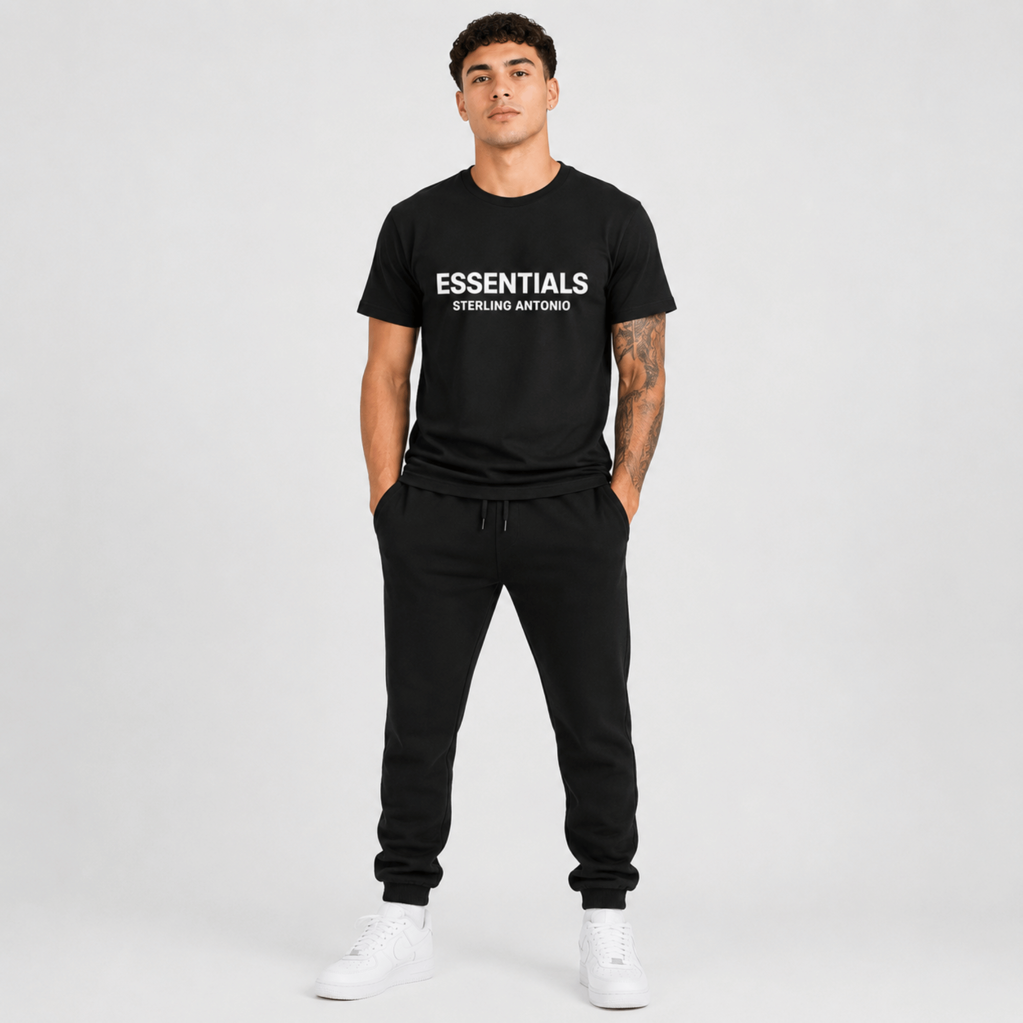 Male fashion model wearing a black Essentials Sterling Antonio cotton jersey t-shirt and black sweatpants.