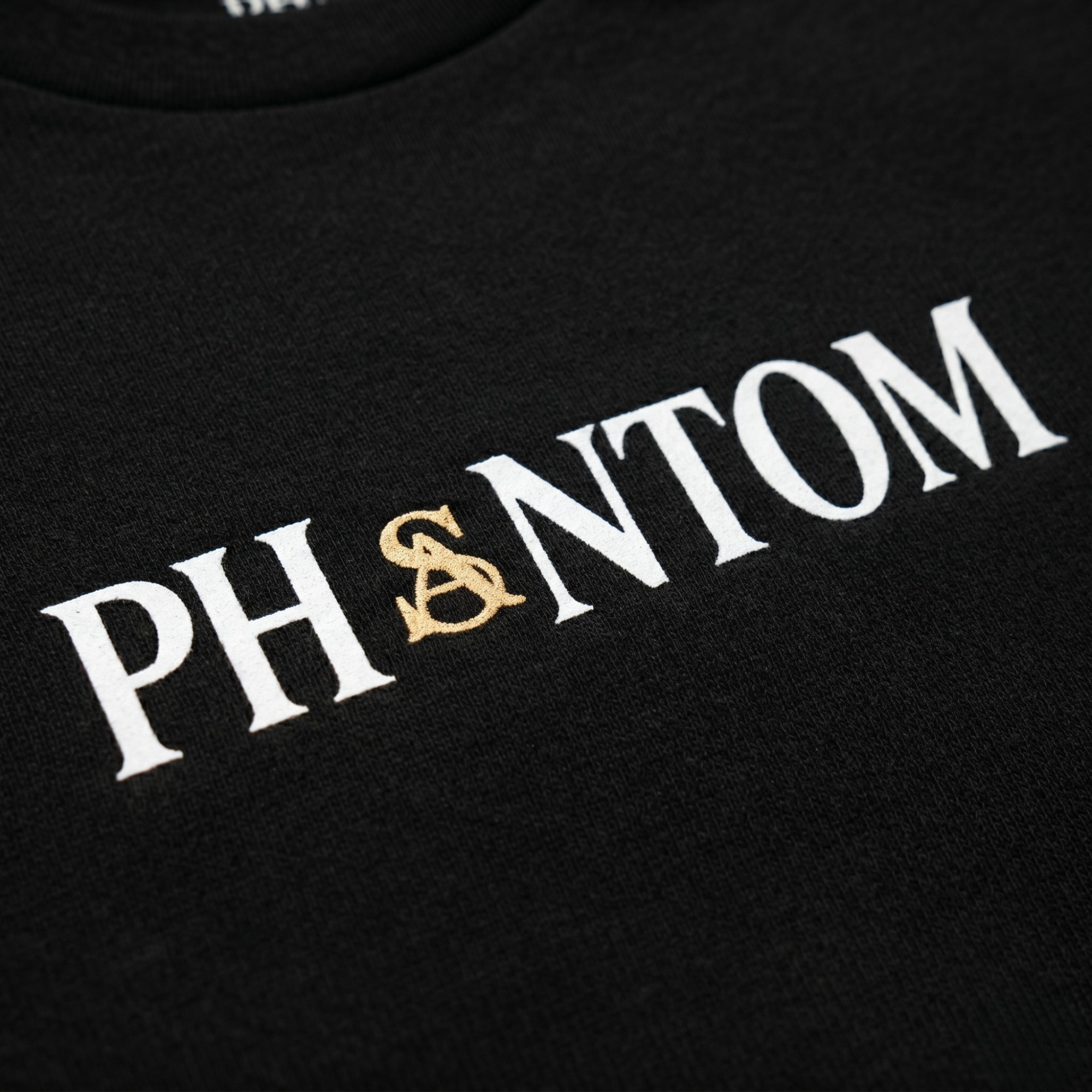 Black shirt with 'PHANTOM' printed in white and gold on a black background