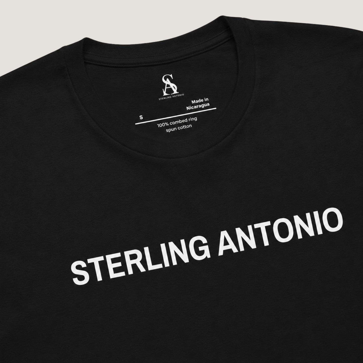 Black t-shirt with 'STERLING ANTONIO' text on a light gray background