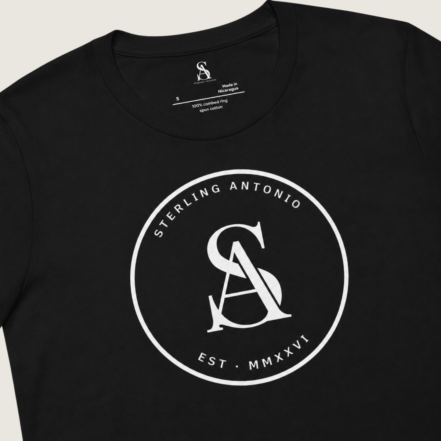 Black t-shirt with white logo and text on a light gray background