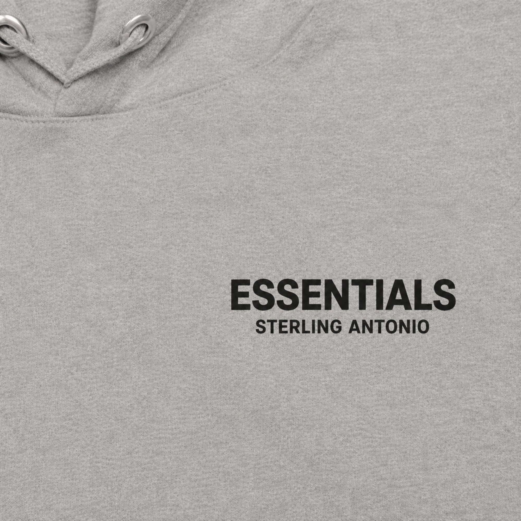 Close-up of Sterling Antonio carbon grey essentials hoodie featuring minimalist black logo print and premium cotton fabric texture