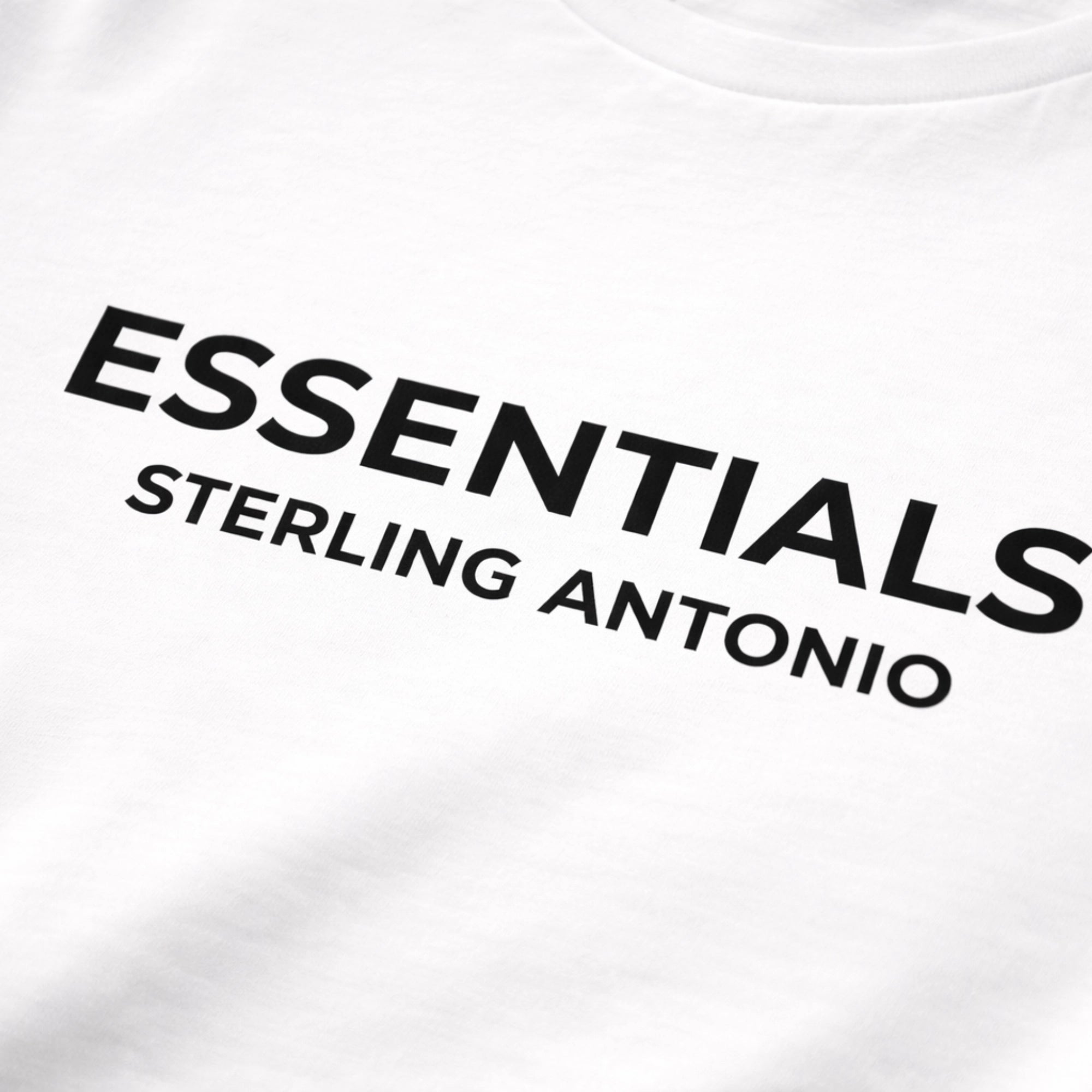 White t-shirt with 'ESSENTIALS STERLING ANTONIO' text in black