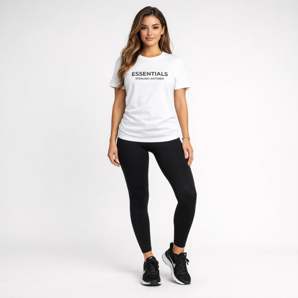 Woman wearing a white t-shirt with 'ESSENTIALS' text and black leggings on a white background