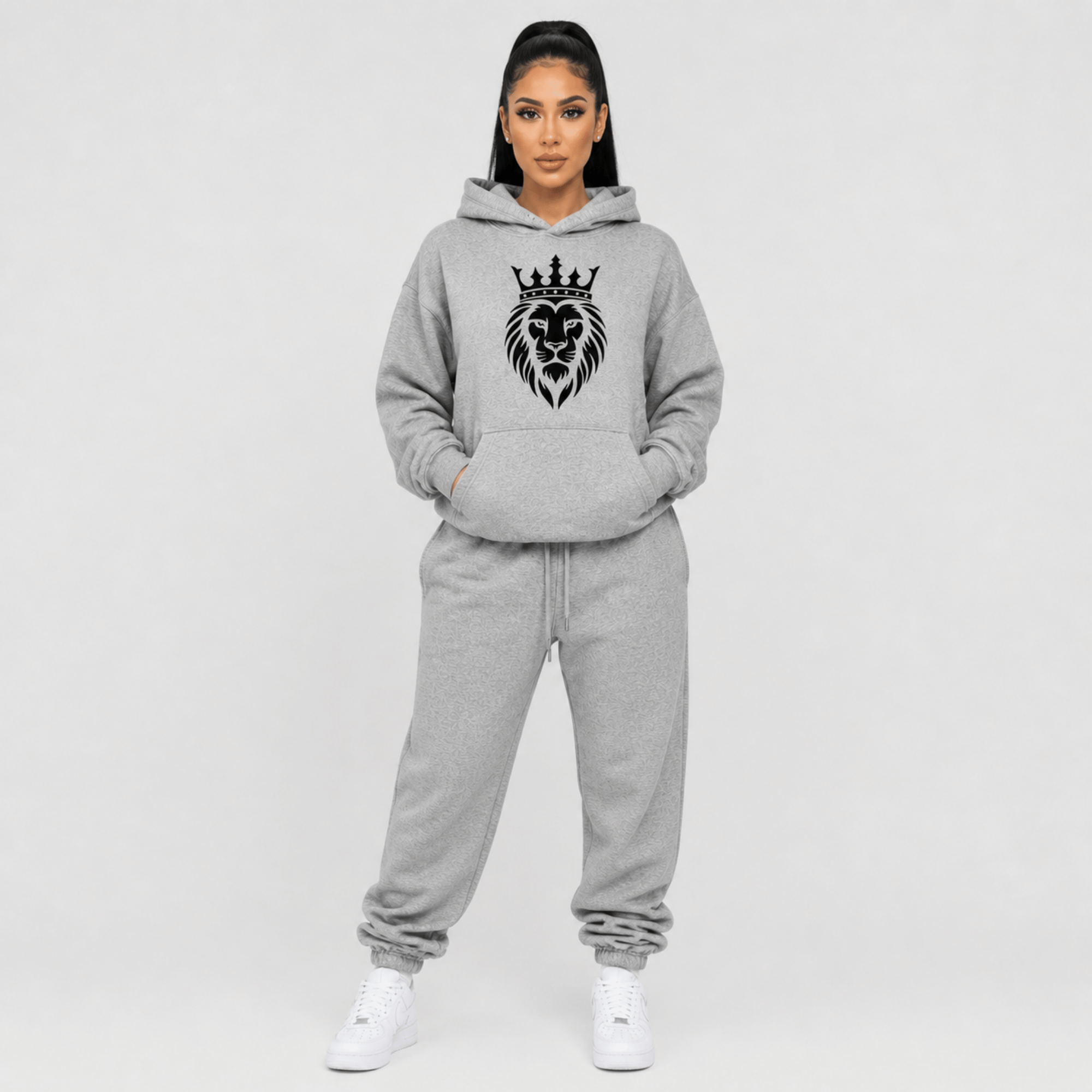 Front view of a person wearing a gray hoodie with a black lion and crown design on a white background