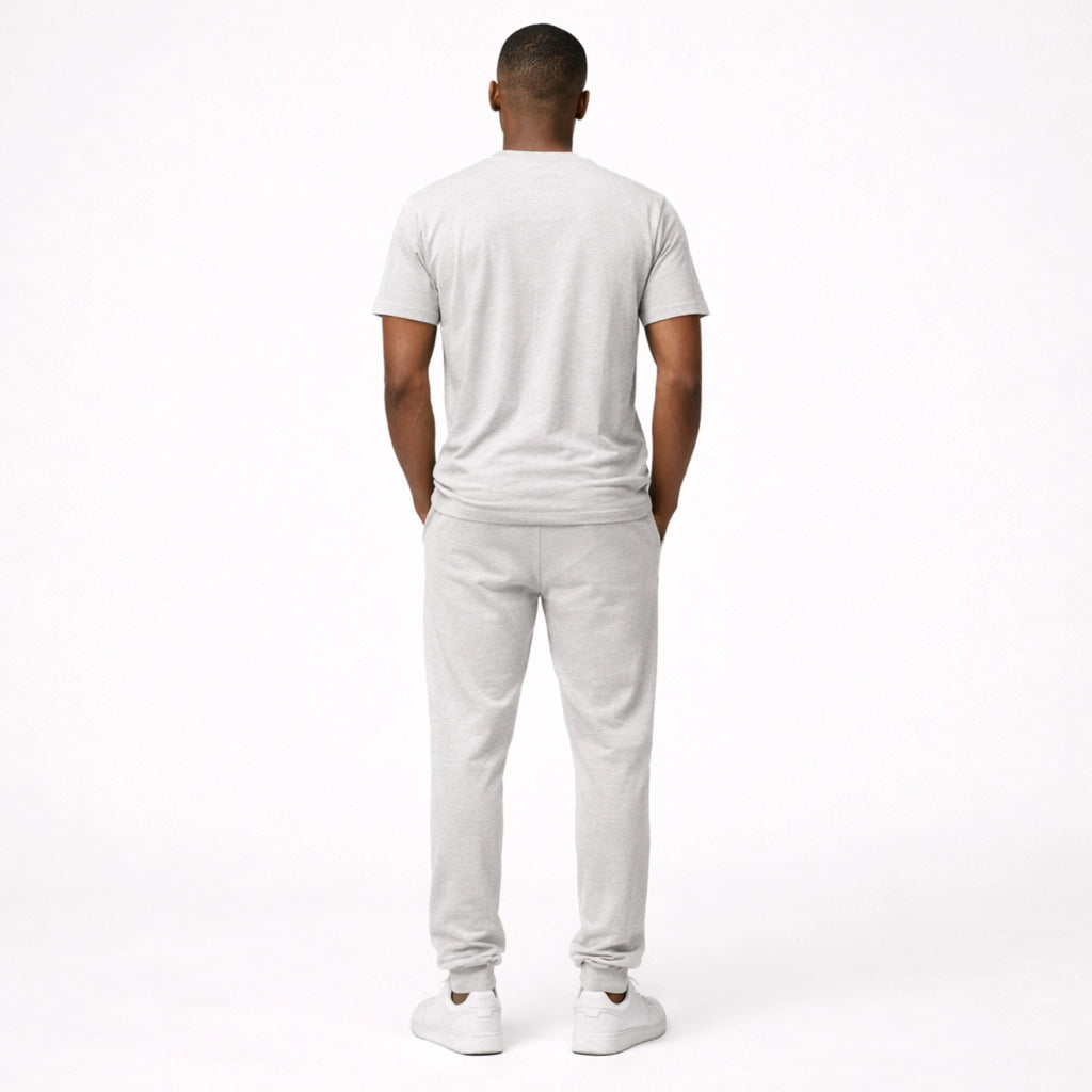 Man wearing a white t-shirt and pants on a white background