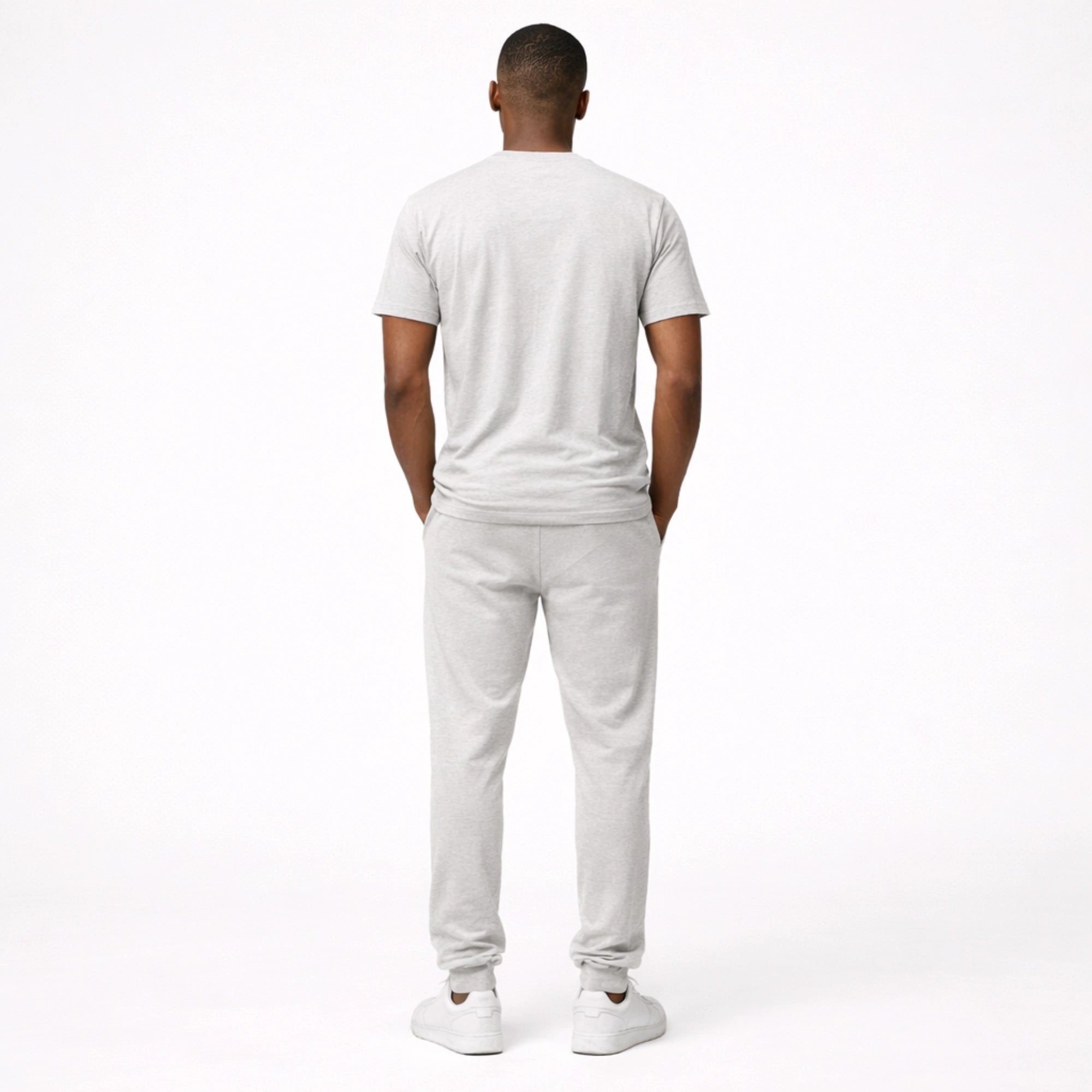 Man wearing a white t-shirt and pants on a white background