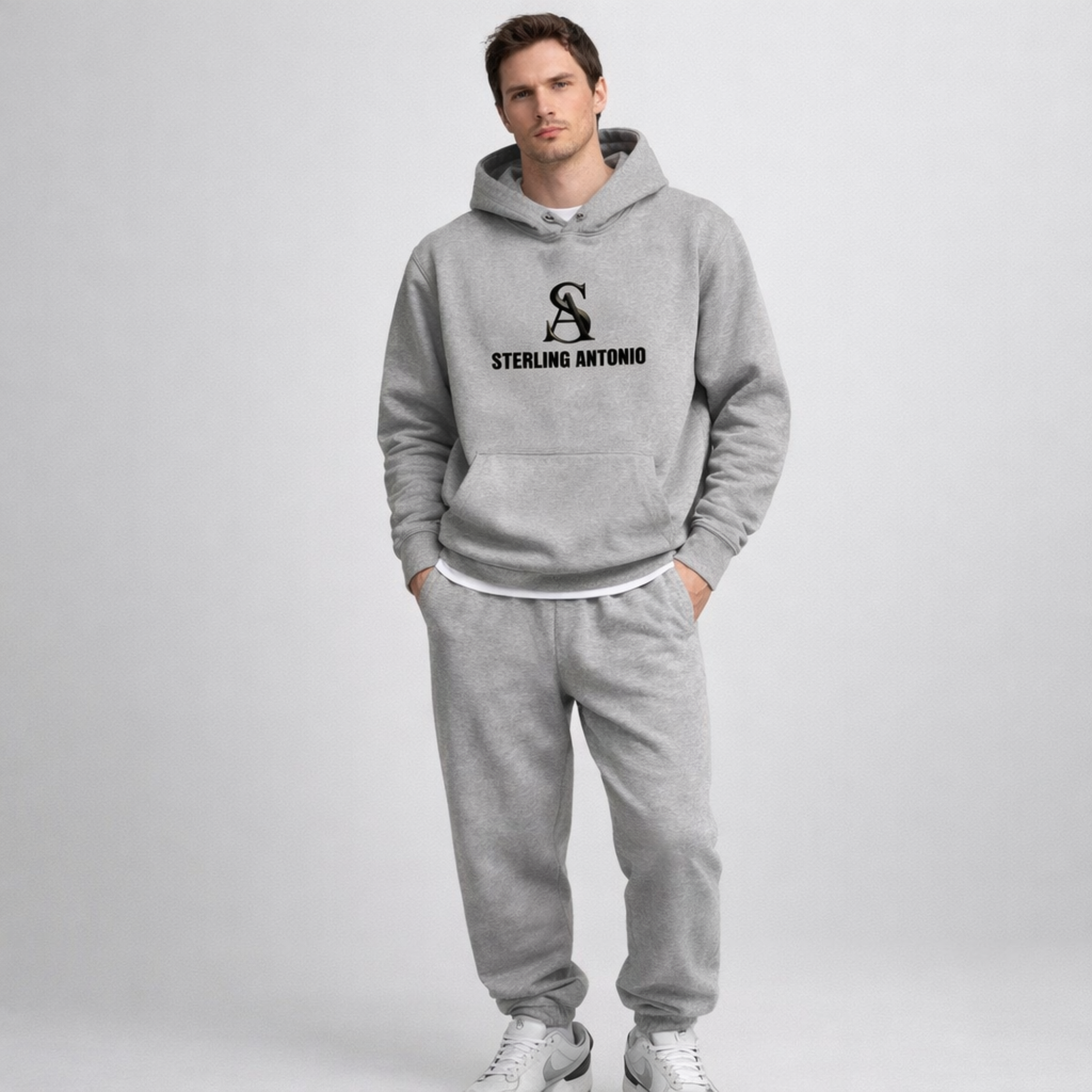 Man wearing a gray hoodie and pants with 'Sterling Antonio' logo on a white background