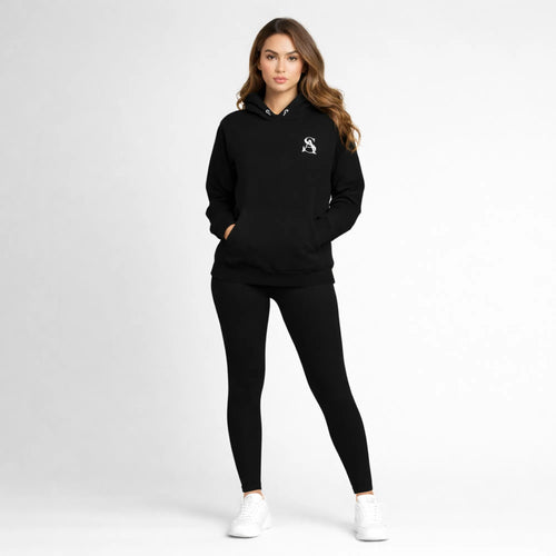 Woman wearing a black hoodie and leggings set with a logo on a white background