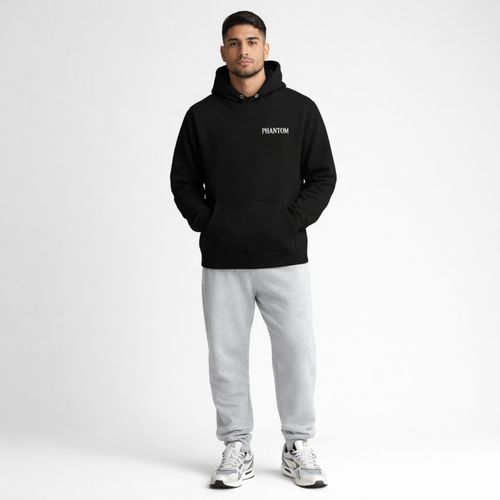 Man wearing a black hoodie with 'PHANTOM' branding and gray sweatpants on a white background