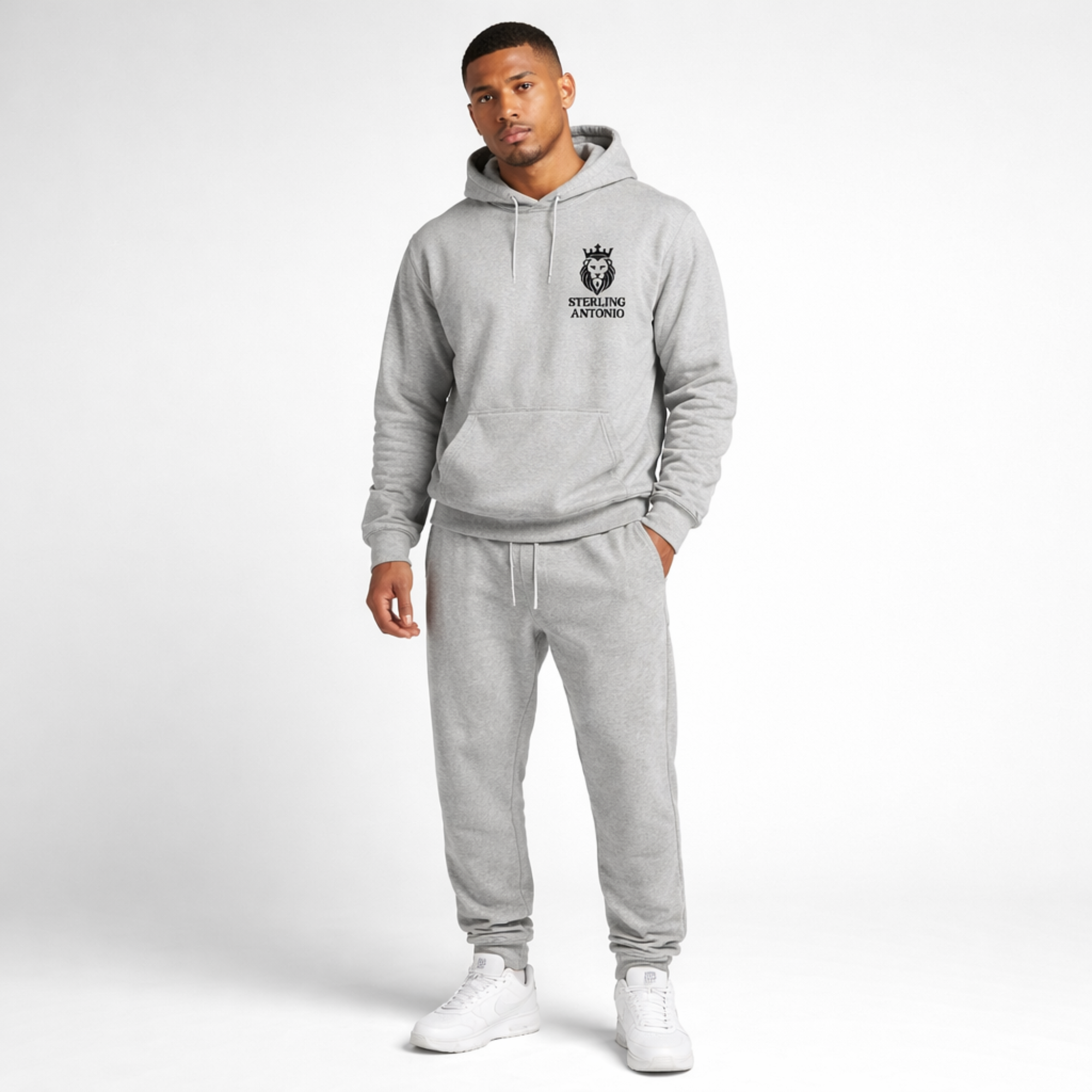 Man wearing a gray hoodie and jogger set with a logo on a white background