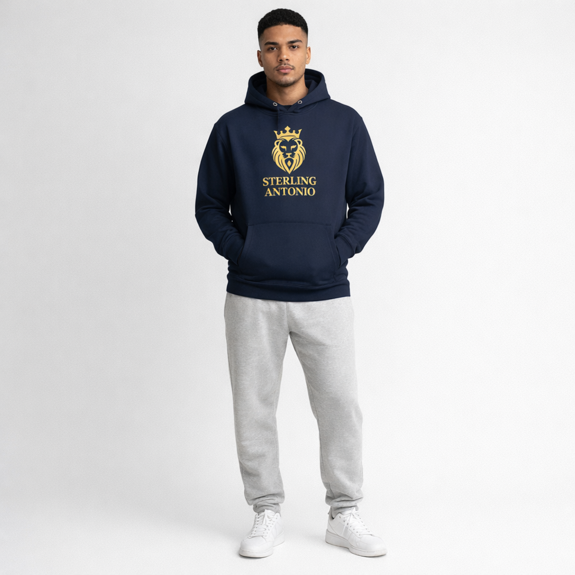 Man wearing a navy hoodie with a logo and text, standing against a white background