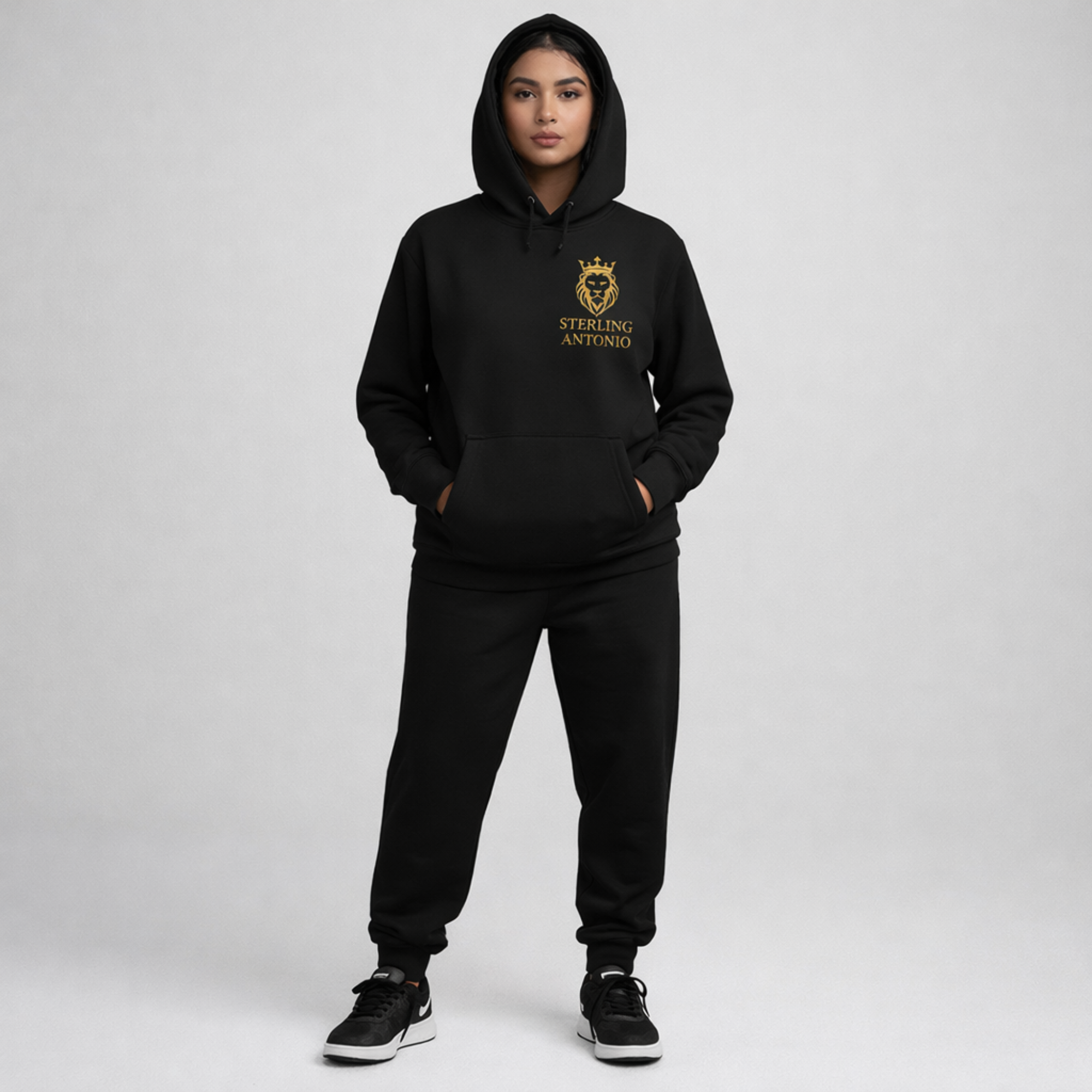 Person wearing a black hoodie and pants with 'Sterling Antonio' logo on a gray background