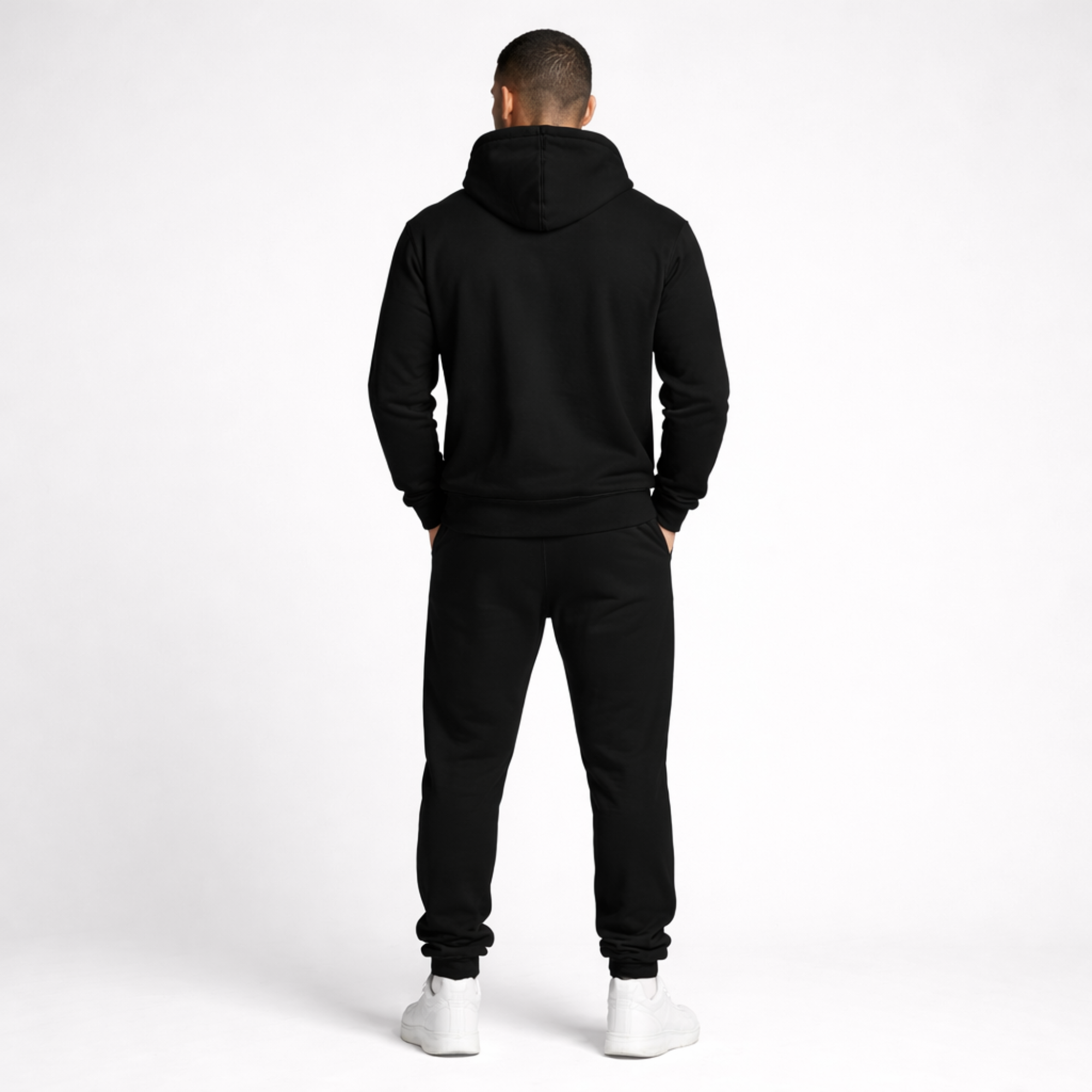 Person wearing a black tracksuit on a white background