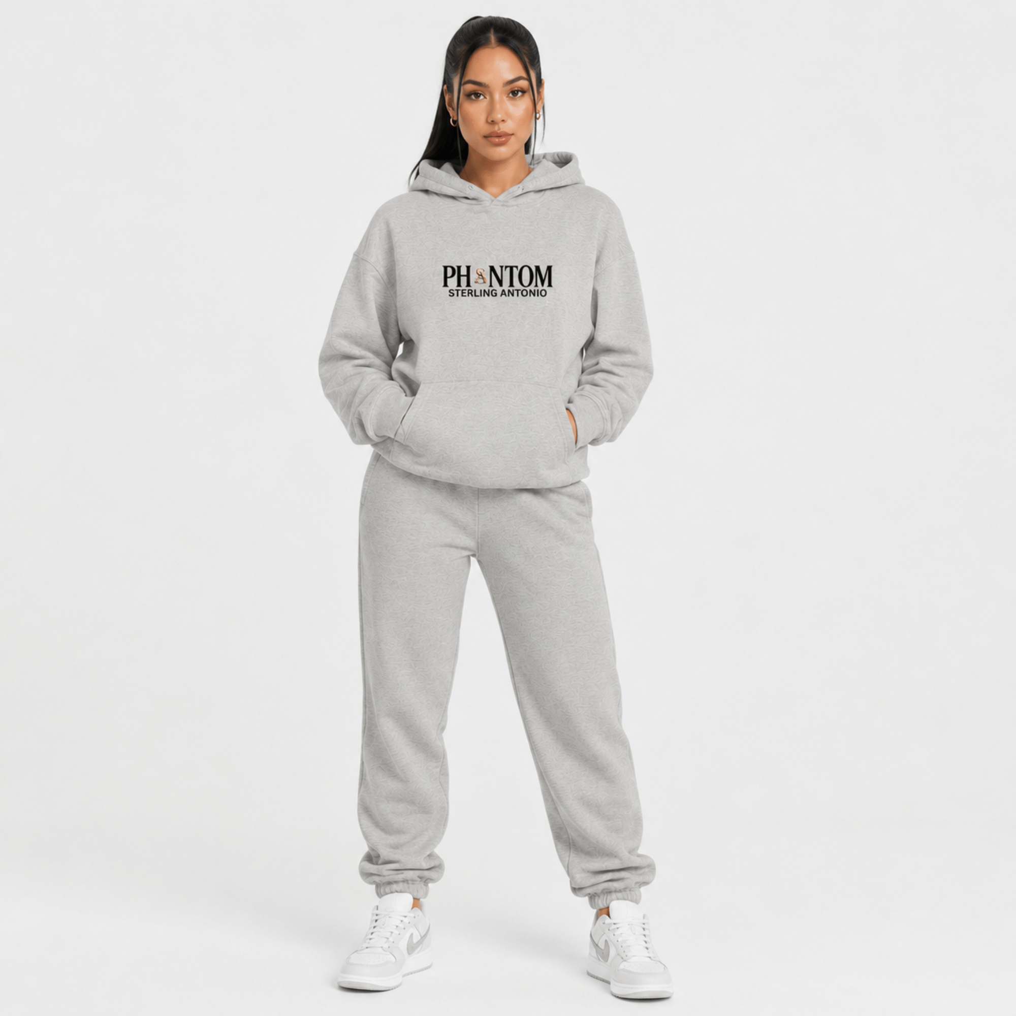 Person wearing a gray hoodie and pants with 'PHANTOM' branding on a white background