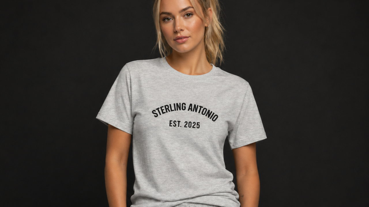 Person wearing a gray t-shirt with 'Sterling Antonio EST. 2025' text on a black background