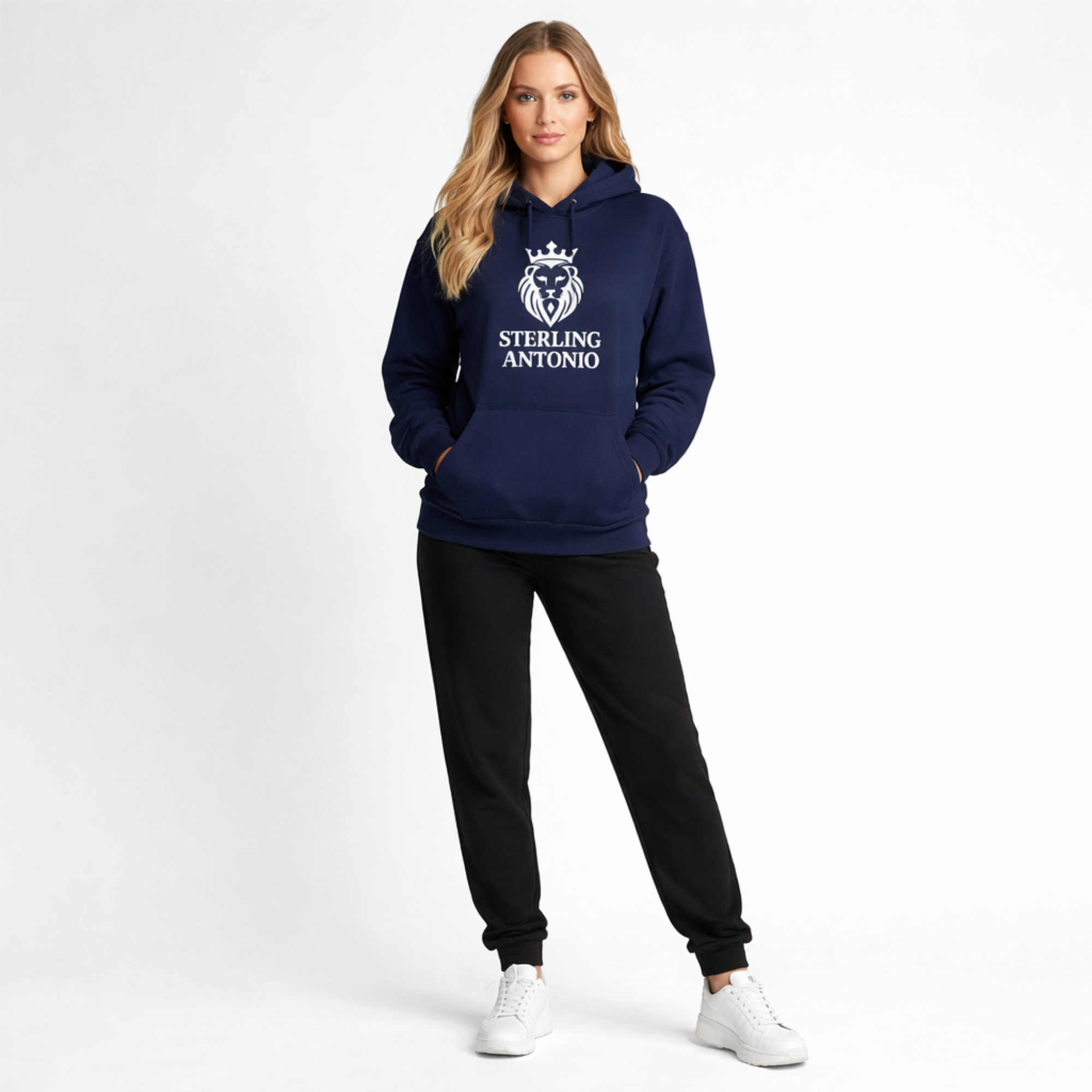 Person wearing a navy hoodie with a logo and text, black pants, and white shoes on a white background