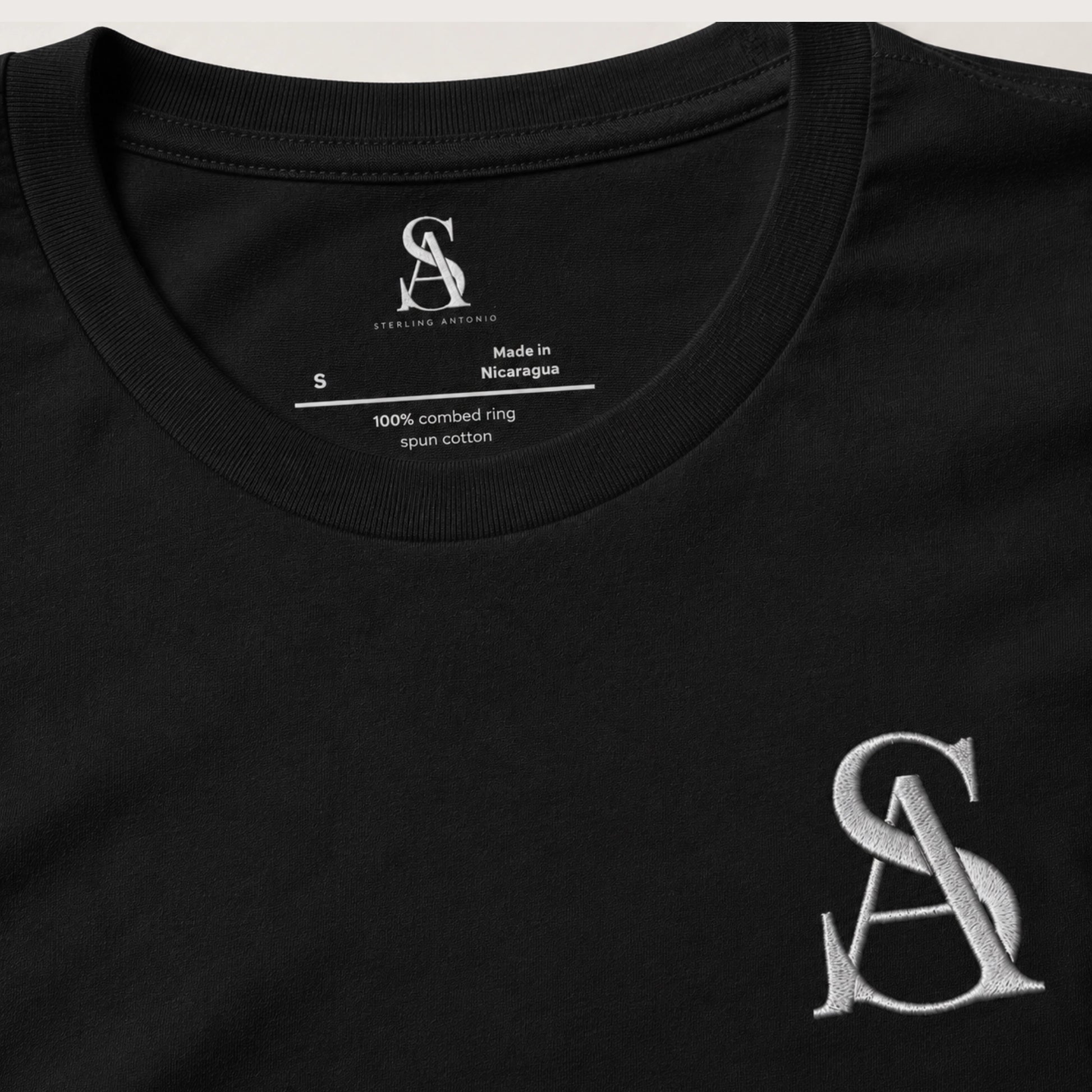 Black t-shirt with a logo and text on a white background