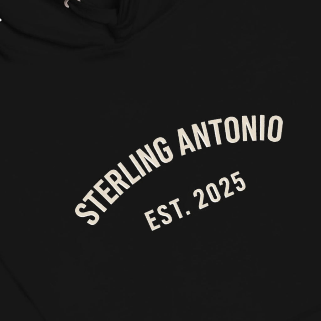 Black hoodie with 'STERLING ANTONIO EST. 2025' text in white on a black background