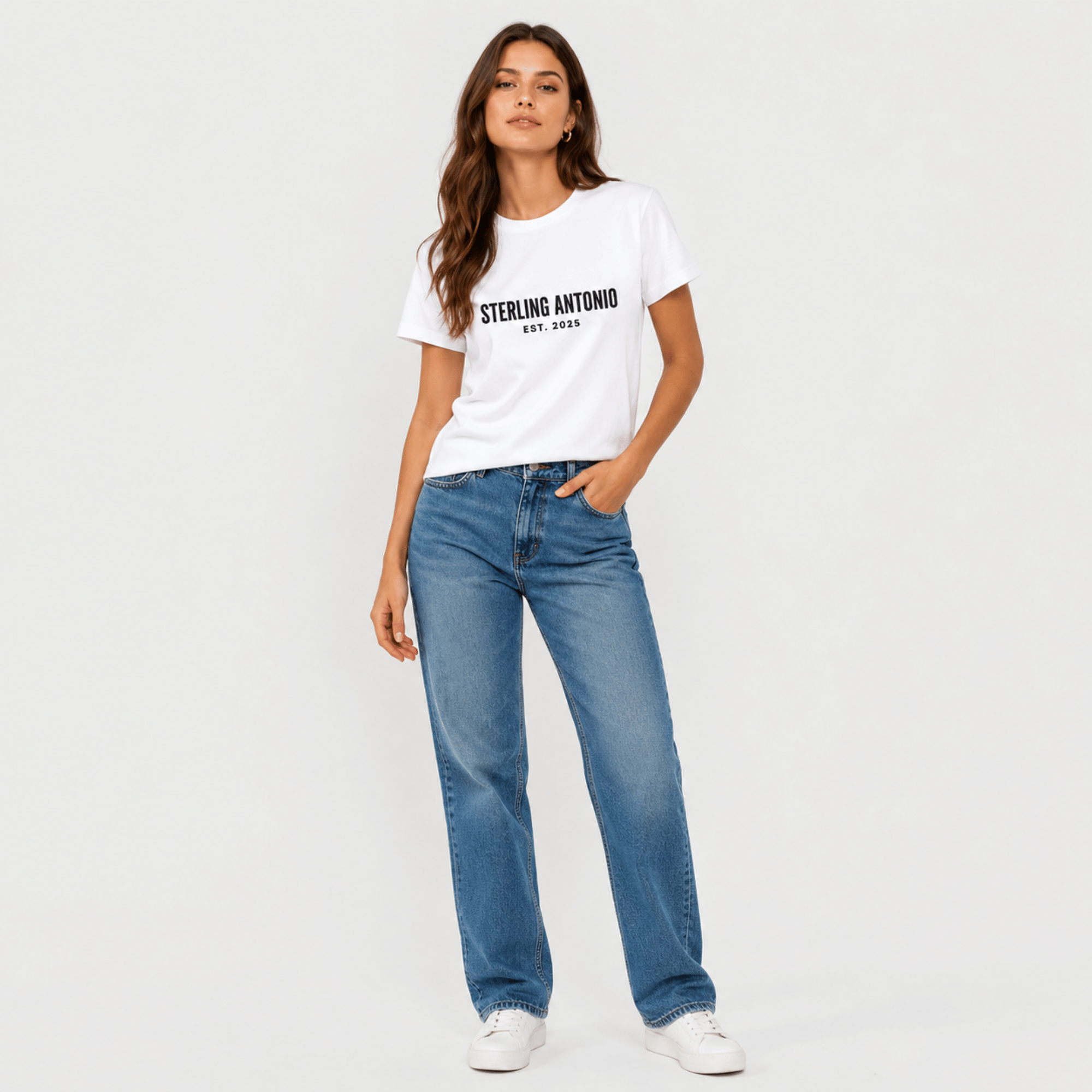 Woman wearing a white t-shirt with text and blue jeans on a plain background