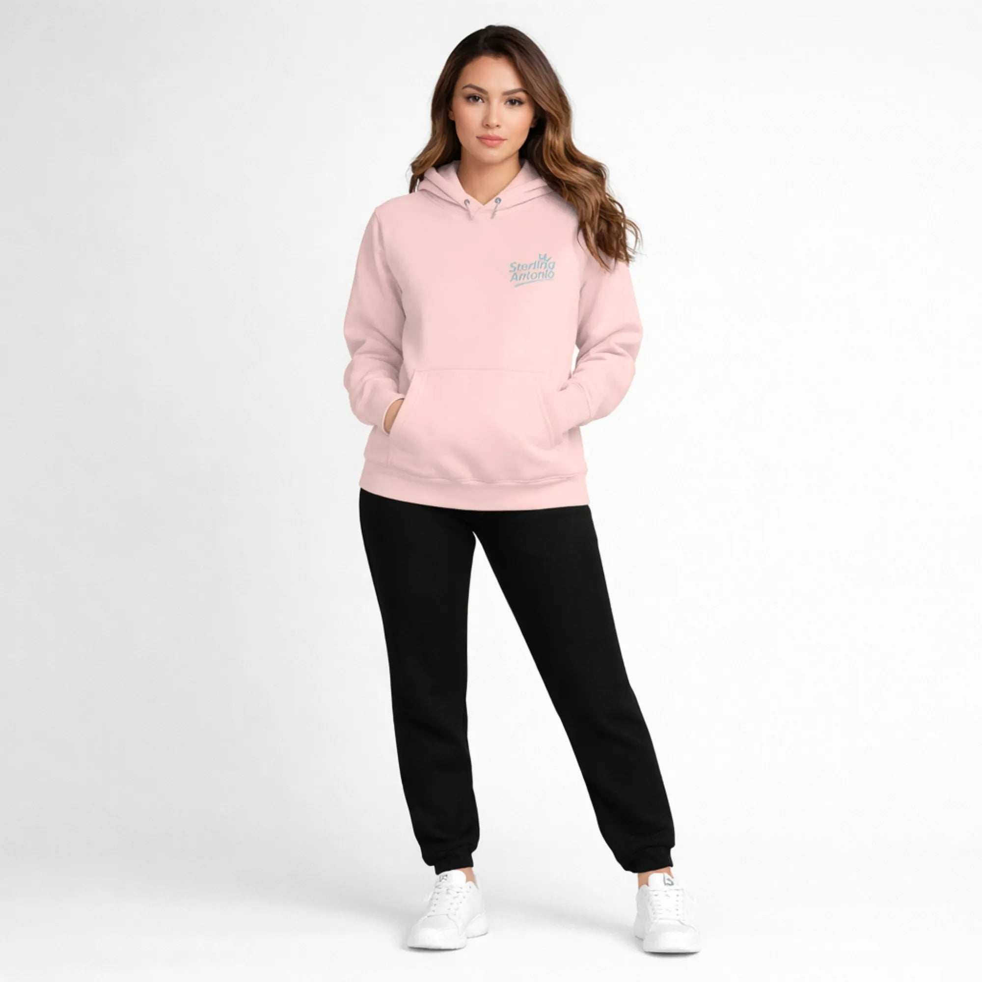 Person wearing a pink hoodie and black pants on a white background