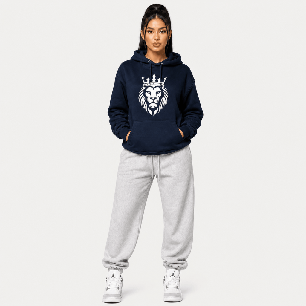 Person wearing a navy hoodie with a lion emblem on a white background