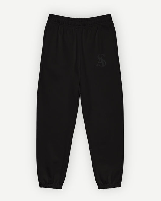 The Black Label Sweatpant in black, front view, with tonal SA monogram embroidered at the left thigh. Sterling Antonio
