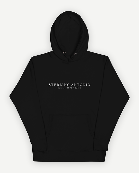 The Founders Hoodie in black, front view, with the Sterling Antonio wordmark and EST. MMXXVI printed in white
