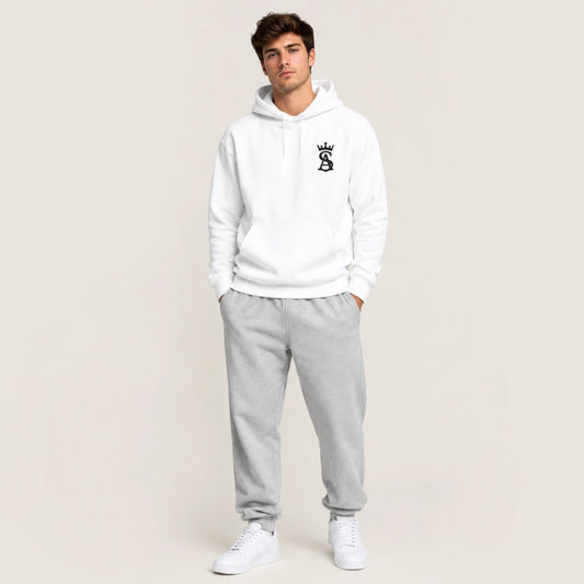 Man wearing a white hoodie and gray sweatpants on a plain background