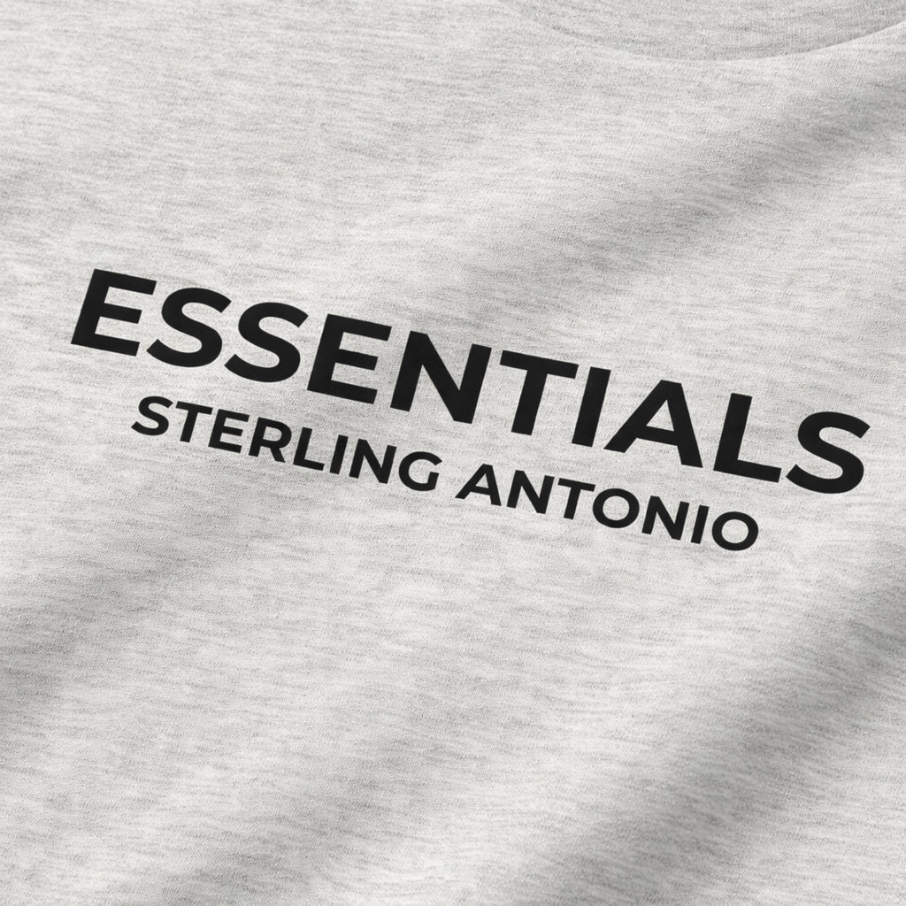 Gray sweatshirt with 'ESSENTIALS STERLING ANTONIO' text on a plain background