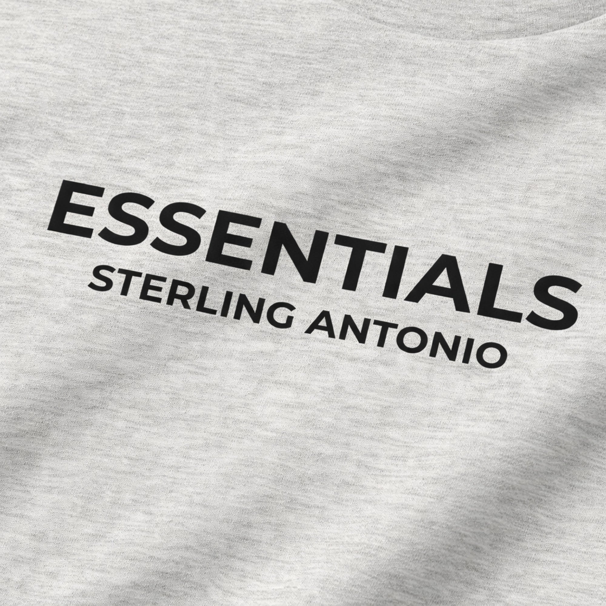 Gray sweatshirt with 'ESSENTIALS STERLING ANTONIO' text on a plain background