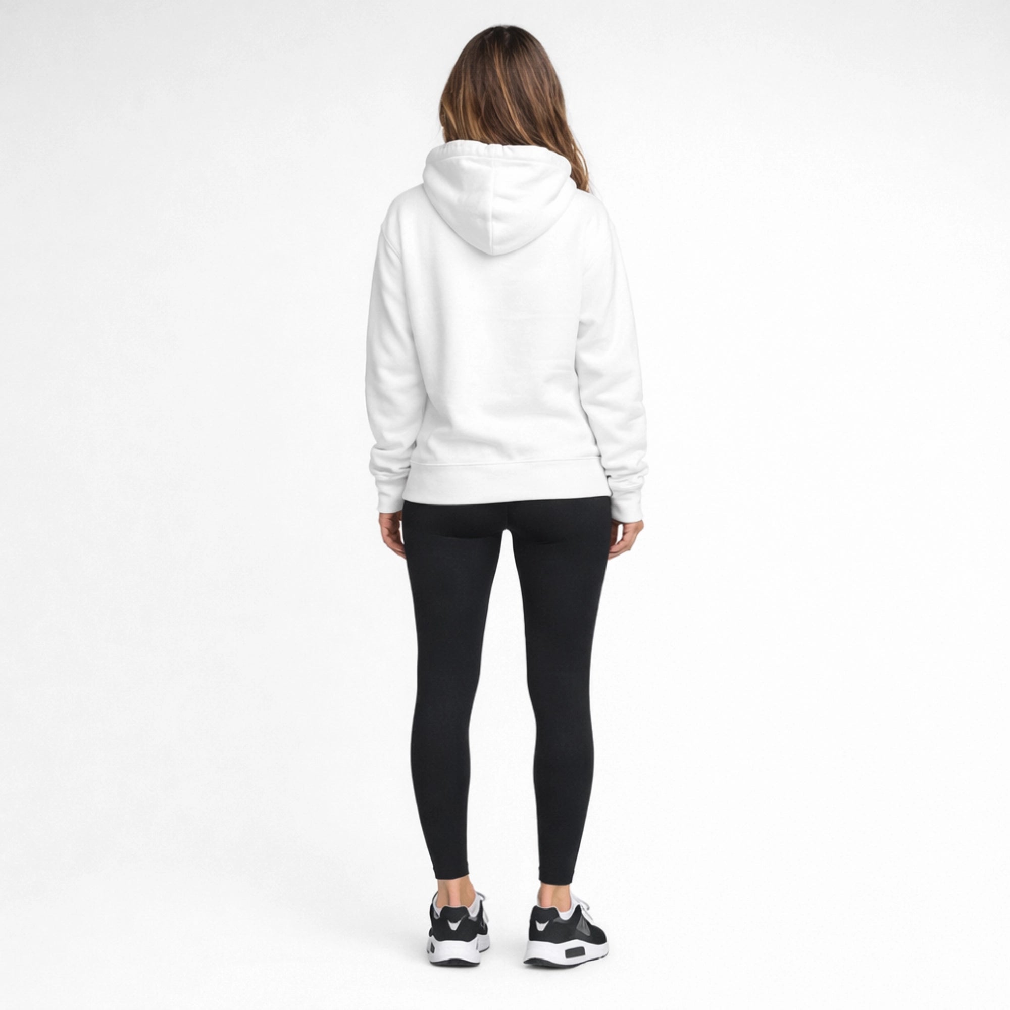 Person wearing a white hoodie and black leggings on a white background